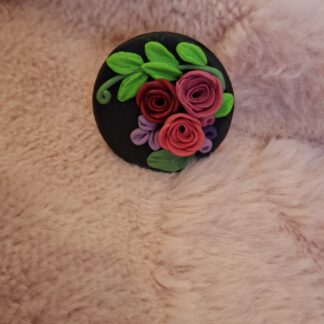 Floral ring with bright hand-painted flowers on a matte black polymer clay base