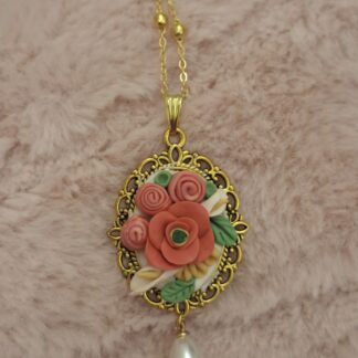 Rose pendant with hand-shaped polymer clay roses in a gold-tone frame and dangling pearl